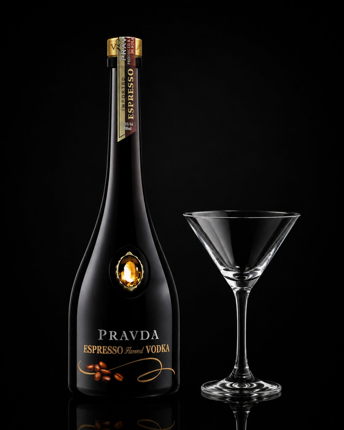 A bottle of Pravda Espresso Vodka next to a clear glass martini coupe on a black reflective background.